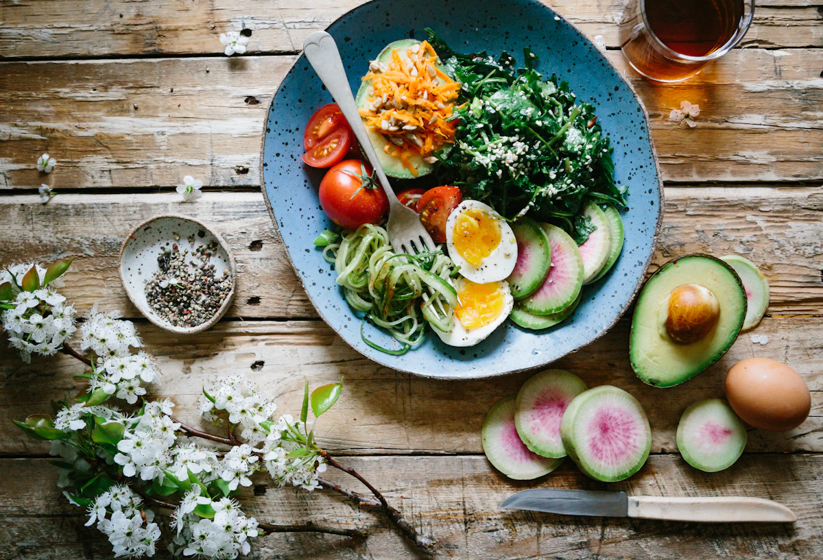 A bowl of chickpeas, avocado and colourful vegetables